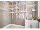 Spacious laundry room with white wire shelving, sink, and cabinet providing ample storage at 216 Billingrath Turn Ln, Cary, NC 27519