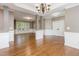 Spacious living room with gleaming hardwood floors and elegant chandelier at 216 Billingrath Turn Ln, Cary, NC 27519