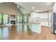 Open-concept living space with fireplace, large windows, and modern kitchen at 216 Billingrath Turn Ln, Cary, NC 27519