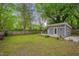 A large backyard features a modern shed with a small deck and a privacy fence at 2442 Stevens Rd, Raleigh, NC 27610