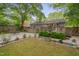 This backyard features a shed, a deck, patio with seating, a grill and garden space at 2442 Stevens Rd, Raleigh, NC 27610