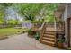 The backyard features a deck, shed, green grass and a grey fence for outdoor entertaining at 2442 Stevens Rd, Raleigh, NC 27610