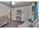 A bedroom features a crib, ceiling fan and hardwood floors plus lots of storage space at 2442 Stevens Rd, Raleigh, NC 27610
