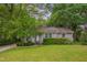 Charming single-story home featuring a well-manicured lawn and beautiful flower bushes at 2442 Stevens Rd, Raleigh, NC 27610