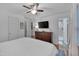 This main bedroom suite features hardwood floors, a ceiling fan, and ensuite bathroom with tile floors at 2442 Stevens Rd, Raleigh, NC 27610