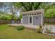 Modern shed with deck, seating and mature landscaping in a lush backyard at 2442 Stevens Rd, Raleigh, NC 27610