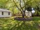 Spacious backyard featuring a shed, mature tree and manicured lawn at 2581 Green Valley Blvd, Burlington, NC 27217