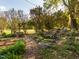 Charming backyard with a custom waterfall feature, mature landscaping, and brick path at 2581 Green Valley Blvd, Burlington, NC 27217
