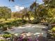 Outdoor space features mature trees, landscaping, decorative brickwork, and a concrete patio at 2581 Green Valley Blvd, Burlington, NC 27217