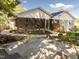 Backyard patio and mature landscaping connect seamlessly with outdoor living spaces and screened porch at 2581 Green Valley Blvd, Burlington, NC 27217