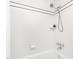 This bathroom features a clean, white tiled shower with a modern showerhead and convenient storage shelves at 2581 Green Valley Blvd, Burlington, NC 27217