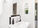 This modern bathroom features a stylish sink, mirror, and a thoughtfully designed storage nook for added convenience at 2581 Green Valley Blvd, Burlington, NC 27217