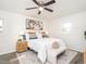 Bright bedroom featuring a ceiling fan, stylish decor, and ample natural light from the surrounding windows at 2581 Green Valley Blvd, Burlington, NC 27217