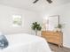 Bright bedroom featuring a ceiling fan, stylish decor, and ample natural light from the surrounding windows at 2581 Green Valley Blvd, Burlington, NC 27217