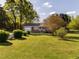 Charming home with lush lawn, mature trees, and a convenient attached garage at 2581 Green Valley Blvd, Burlington, NC 27217
