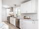 Bright kitchen features white cabinets, stainless steel appliances, and granite countertops, adding a touch of elegance at 2581 Green Valley Blvd, Burlington, NC 27217