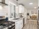 Bright kitchen featuring granite countertops, stainless steel appliances, and white cabinets at 2581 Green Valley Blvd, Burlington, NC 27217