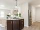 A view of a kitchen island, living room, and stainless steel refrigerator at 2581 Green Valley Blvd, Burlington, NC 27217