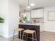 Kitchen island with dark wood base, light countertop, and seating at 2581 Green Valley Blvd, Burlington, NC 27217
