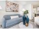 Bright living room with blue couch, white walls, modern art, and decor at 2581 Green Valley Blvd, Burlington, NC 27217