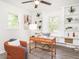 Well-lit home office featuring built-in shelving, desk, and comfortable seating, perfect for productivity at 2581 Green Valley Blvd, Burlington, NC 27217