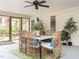 Relaxing screened porch featuring comfortable seating, a ceiling fan, and outdoor access at 2581 Green Valley Blvd, Burlington, NC 27217