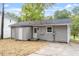 Back exterior featuring gray siding, newly replaced roof, and lots of space at 2612 Glenbrook Dr, Durham, NC 27704