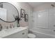 Modern bathroom with a shower-tub combo and a white countertop vanity at 2612 Glenbrook Dr, Durham, NC 27704