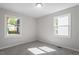 Bright bedroom with large windows bringing in natural light and plush new carpet at 2612 Glenbrook Dr, Durham, NC 27704