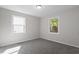 Bedroom with neutral paint and plush new carpet featuring large windows for ample natural light at 2612 Glenbrook Dr, Durham, NC 27704