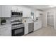 Contemporary kitchen featuring stainless steel appliances, ample counter space, and white cabinetry at 2612 Glenbrook Dr, Durham, NC 27704
