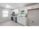 Updated kitchen with white cabinetry, stainless steel appliances, and modern backsplash at 2612 Glenbrook Dr, Durham, NC 27704