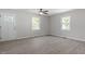 Inviting living room with wood-look floors, two large windows, and an entrance to the home at 2612 Glenbrook Dr, Durham, NC 27704