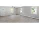 Bright living room featuring new floors, neutral paint, ceiling fan, and natural light from the exterior windows at 2612 Glenbrook Dr, Durham, NC 27704