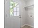 Mud room entrance features a windowed door and leads to the laundry hookups with white storage shelves at 2612 Glenbrook Dr, Durham, NC 27704