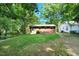 Expansive backyard with lush lawn, mature trees and brick home is perfect for outdoor activities at 2709 Farthing St, Durham, NC 27704
