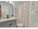 Cozy bathroom featuring a shower-tub combo and a stylish patterned shower curtain at 2709 Farthing St, Durham, NC 27704