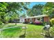 Charming front yard featuring a well-maintained lawn and colorful flower beds, complemented by a birdbath at 2709 Farthing St, Durham, NC 27704