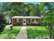 Charming single-story brick home featuring a well-manicured lawn and mature trees at 2709 Farthing St, Durham, NC 27704