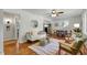 Bright living room featuring hardwood floors, a ceiling fan, and abundant natural light at 2709 Farthing St, Durham, NC 27704