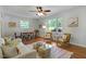 Inviting living room with hardwood floors and natural light flowing through large windows at 2709 Farthing St, Durham, NC 27704