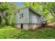 View of the home's side exterior showing a concrete block foundation and siding at 2733 Thelma St, Durham, NC 27704