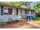 Close up of the front exterior featuring a blue home with black shutters and front porch entrance at 2733 Thelma St, Durham, NC 27704