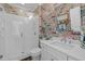 Charming bathroom featuring a glass shower, stylish sink and vanity, and unique wallpaper at 2908 Stubble Field Dr, Raleigh, NC 27613
