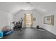 Spacious bonus room features a large window, rubber floors, and workout equipment at 2908 Stubble Field Dr, Raleigh, NC 27613
