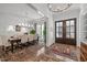 Elegant dining room featuring hardwood floors, stylish lighting, and french doors, perfect for entertaining guests at 2908 Stubble Field Dr, Raleigh, NC 27613