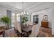 Bright dining room with hardwood floors, neutral paint, a large table, and stylish chandelier at 2908 Stubble Field Dr, Raleigh, NC 27613