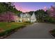 Stately white home with charming landscaping and beautiful flowering trees at twilight at 2908 Stubble Field Dr, Raleigh, NC 27613
