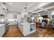 A gourmet kitchen featuring an island with built in bookshelves, and easy access to the living room at 2908 Stubble Field Dr, Raleigh, NC 27613