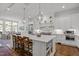 Spacious kitchen featuring a large island with seating, pendant lighting, and an open layout to the dining area at 2908 Stubble Field Dr, Raleigh, NC 27613